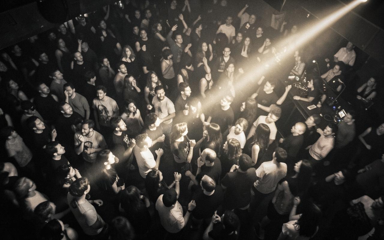 Crowd seen from above, lit by a single beam of light